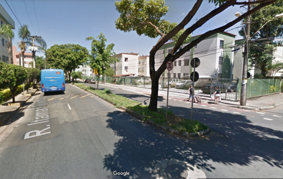 Imagem mostra a Rua Itamar Teixeira, no Bairro Betânia, ladeada por prédios de um conjunto habitacional; 