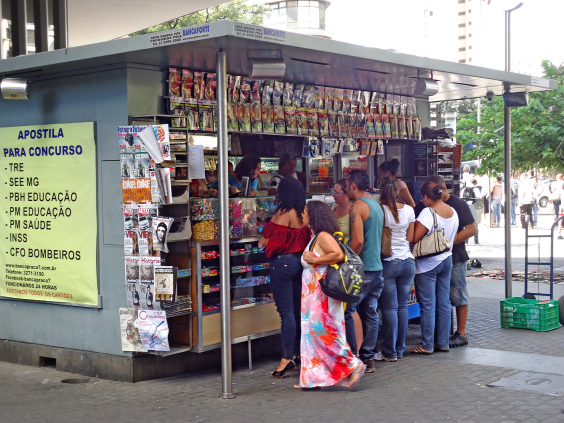 Banca de jornal com clientes aguardando atendimento