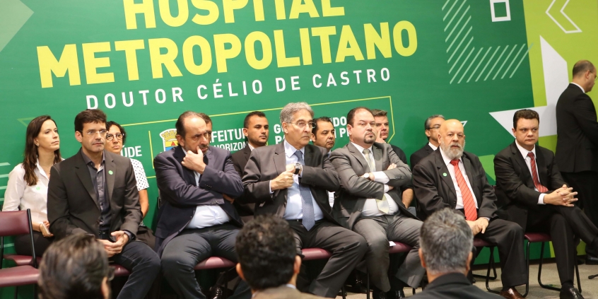 Autoridades compõem mesa de solenidade com painel do hospital metropolitano ao fundo