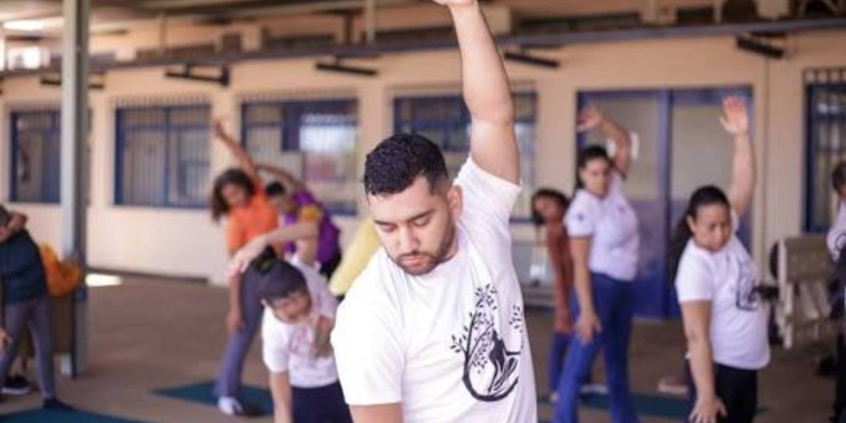 grupo de pessoas realiza  exercícios de alongamento