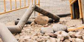 Canteiro de obras com pedras e canos retorcidos