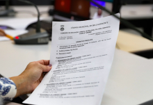 Mão segura documento com proposições em pauta
